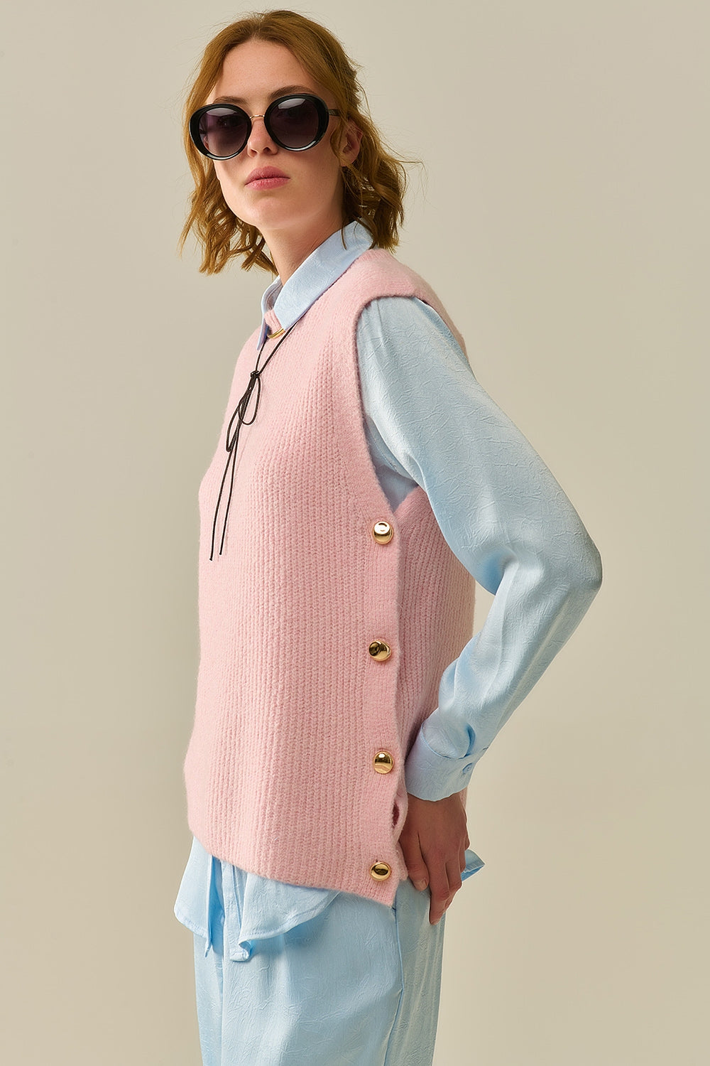 Pink sleeveless sweater with gold buttons