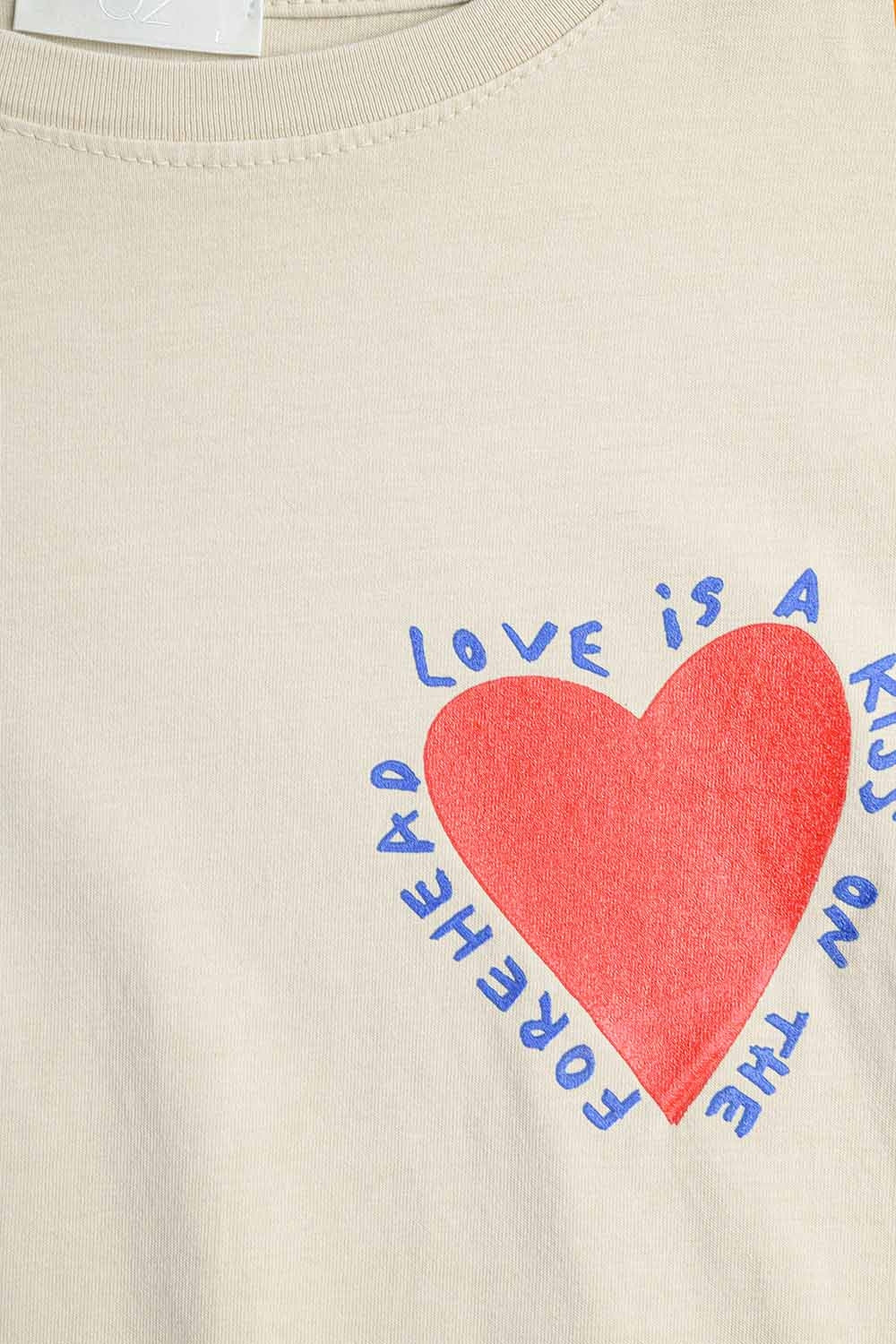 Relaxed beige T-shirt featuring a heart design on both the front and back