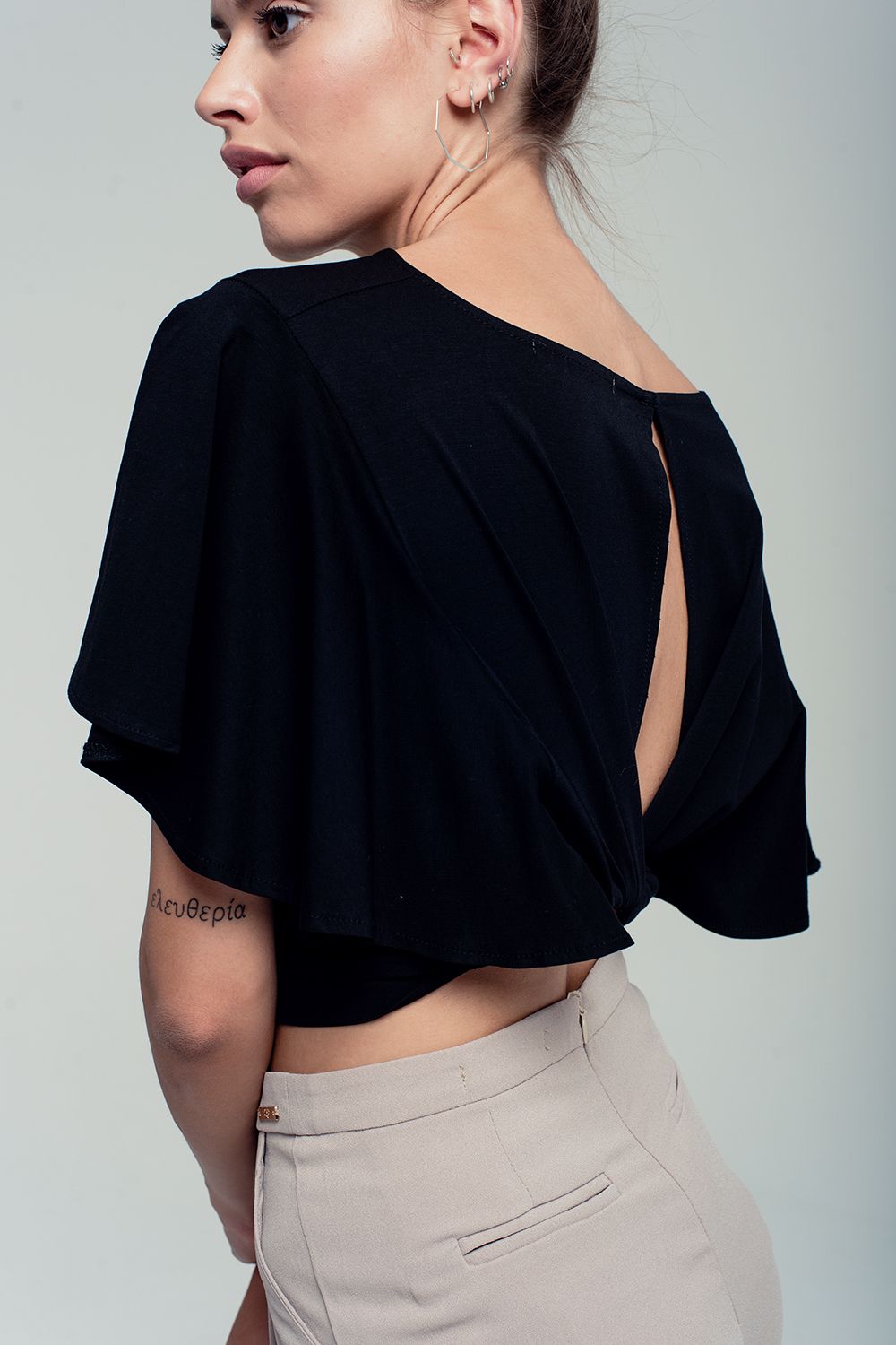Ruffled sleeves black crop top with open back and bow detail