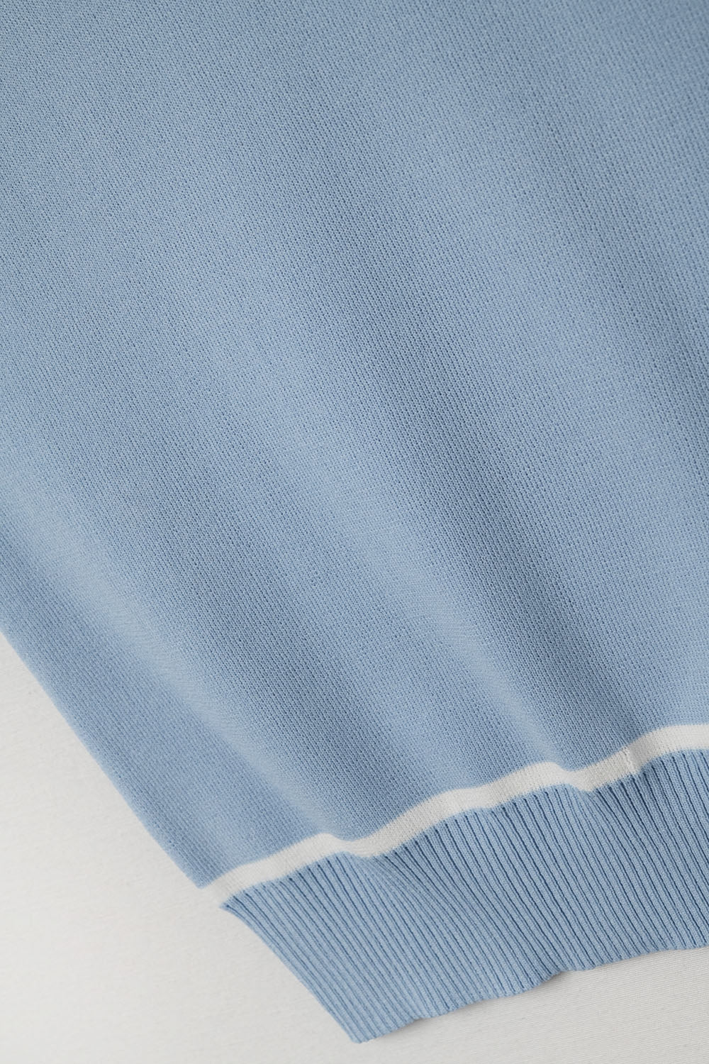 Sleeveless Sweater In Blue Featuring White Lines detail