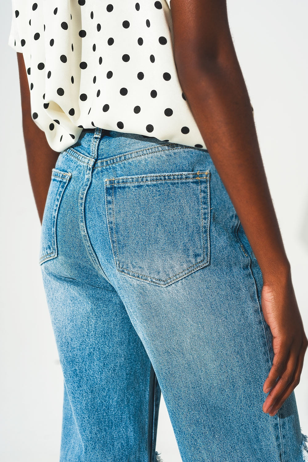 Straight jean in medium wash with rip and split hem