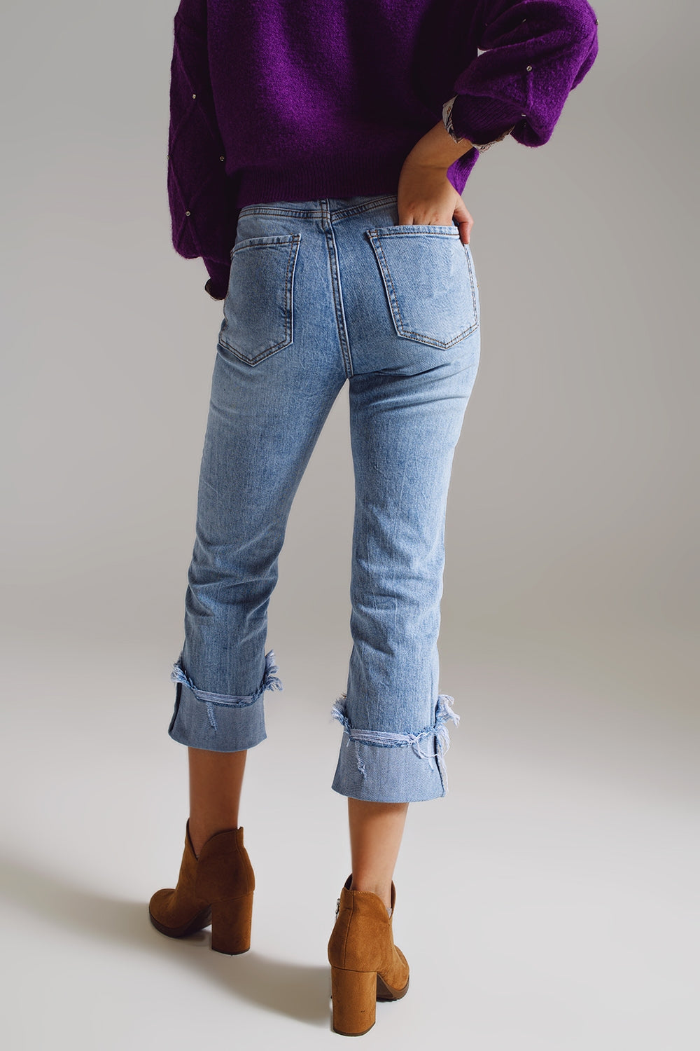 Straight leg jeans with distressed hem in light blue
