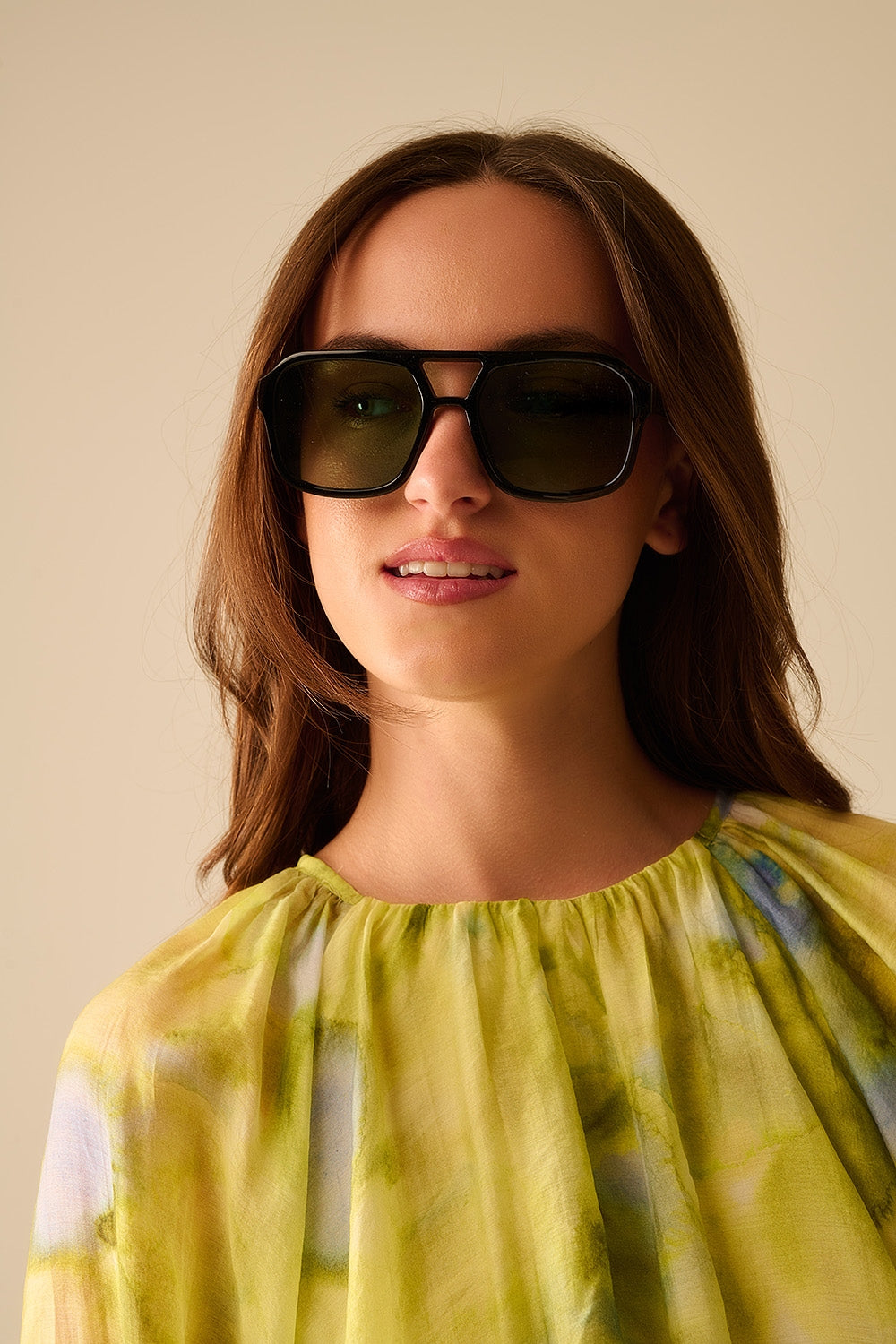 Sunglasses with black frames and green lenses