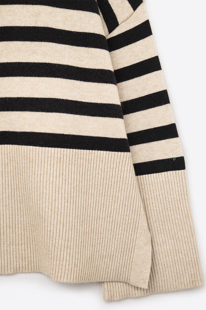 Beige oversized turtleneck sweater with black stripes and splits on the side