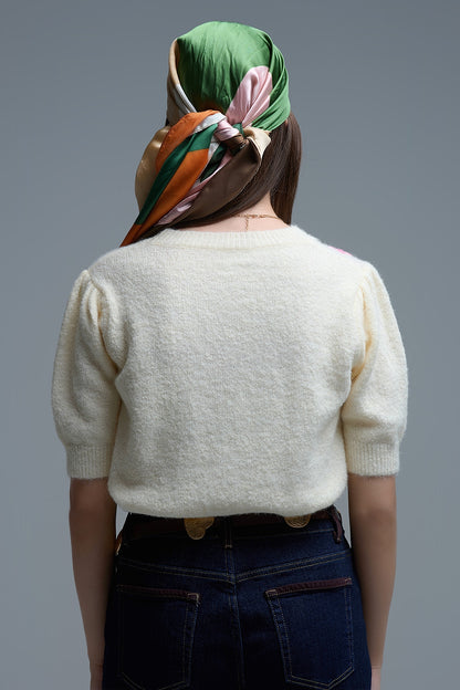 Cream chunky knit short-sleeved sweater with pastel-colored embroidered flowers