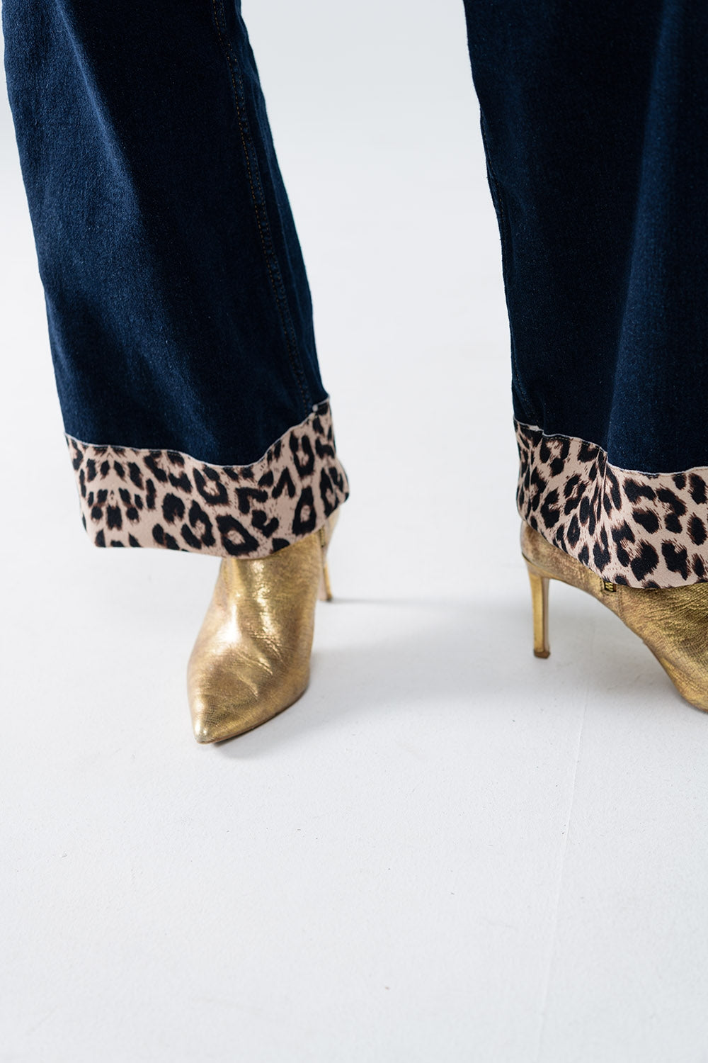 Dark wash wide leg jeans with leopard detail at the bottom