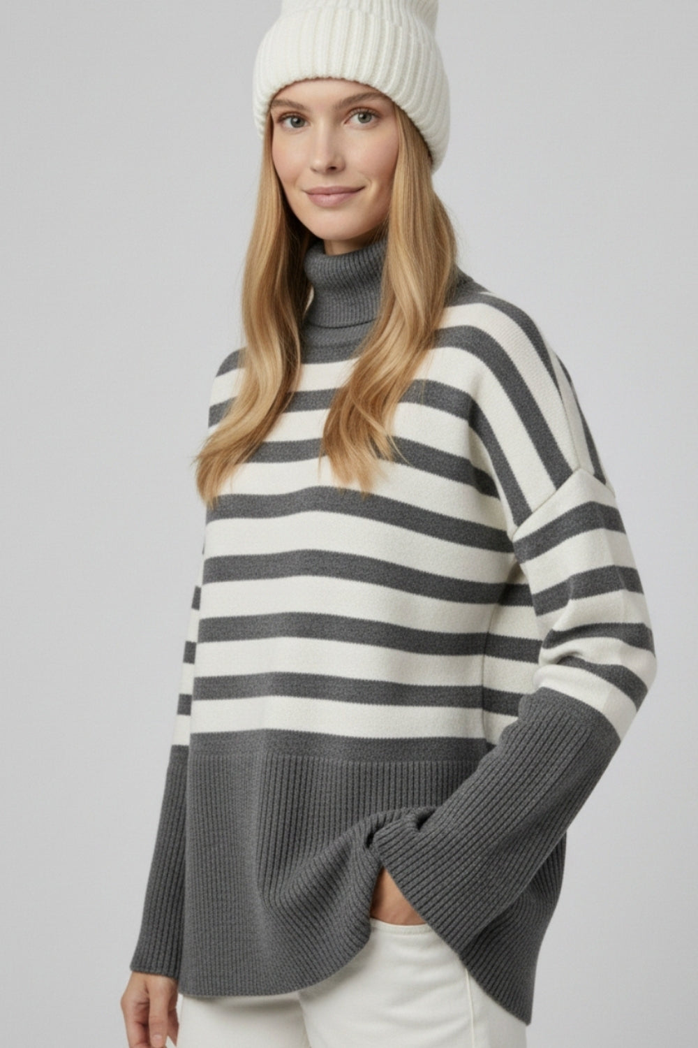 Gray oversized turtleneck sweater with white stripes and splits on the side
