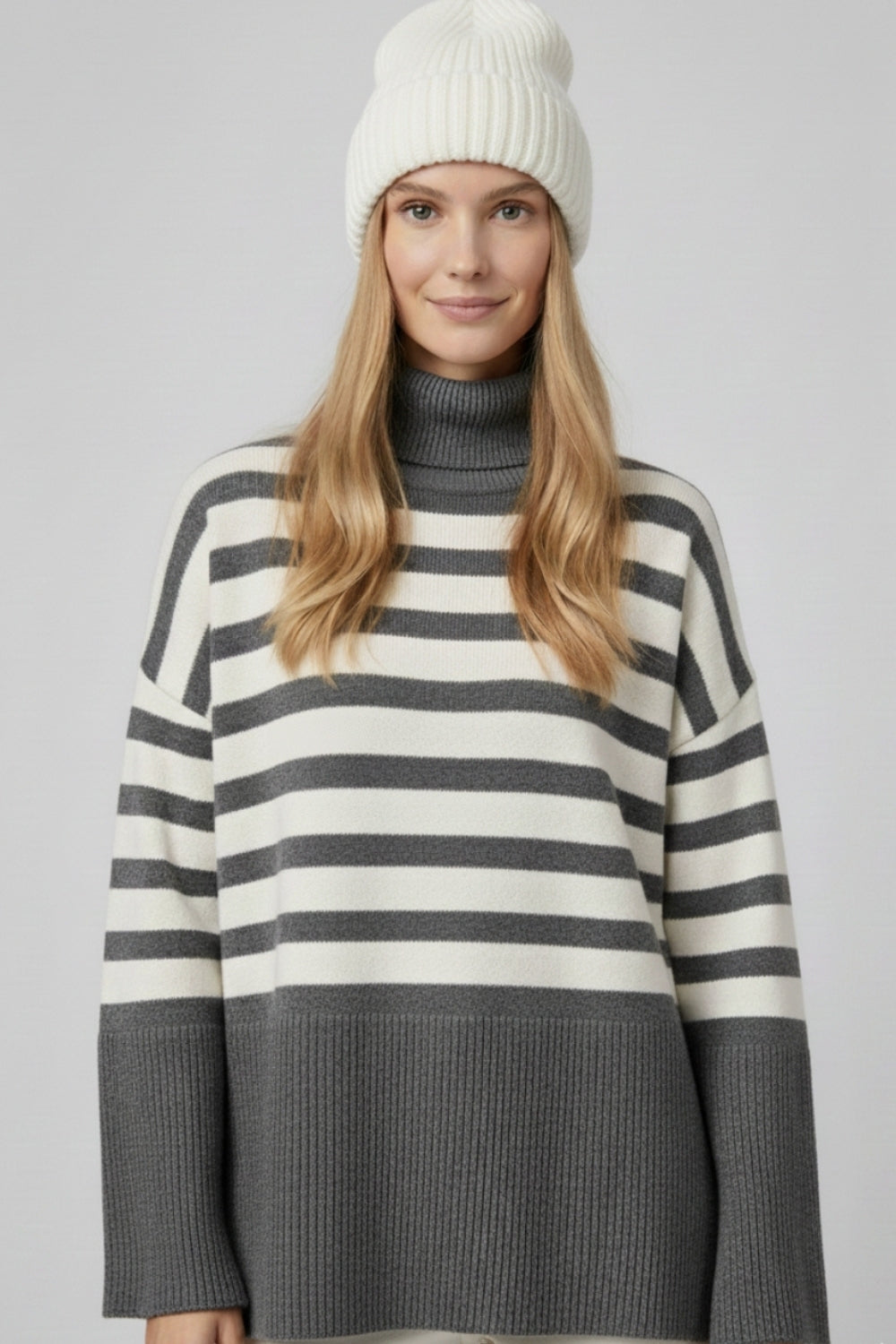 Gray oversized turtleneck sweater with white stripes and splits on the side