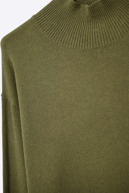 Loose military green sweater with open back detail