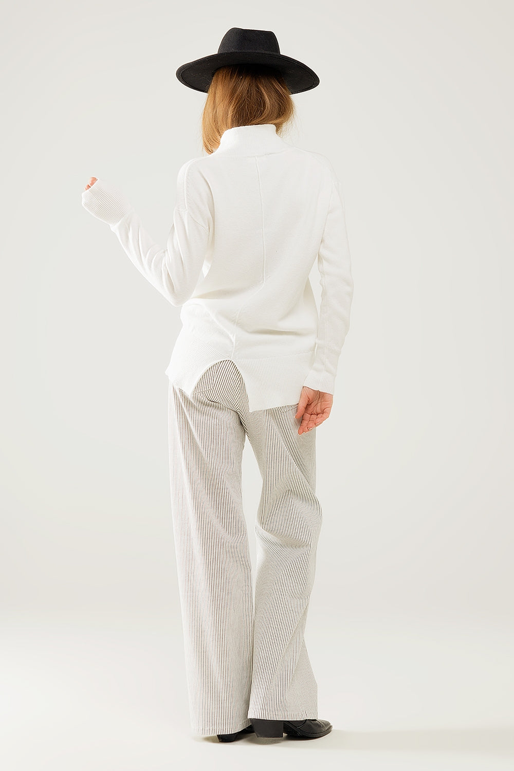 Loose white sweater with open back detail