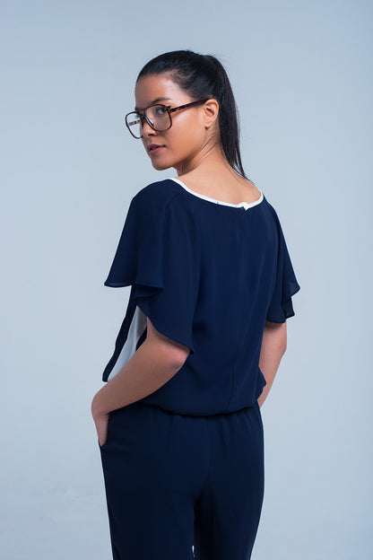Navy blue jumpsuit with short sleeve and ruffle detail