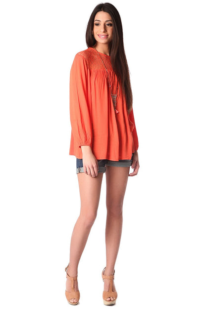 Orange smock blouse with cage detail