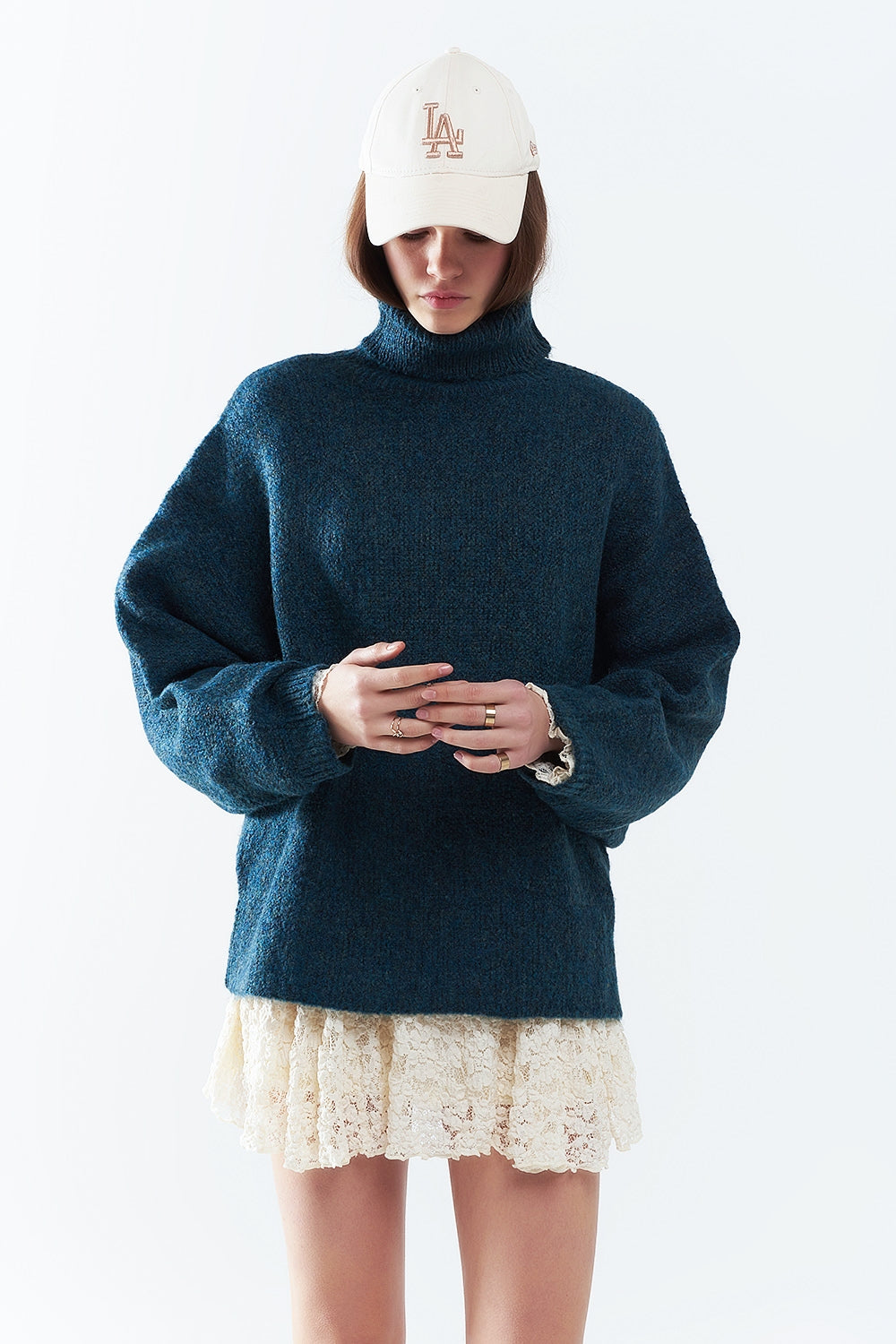 Oversized sweater in teal with a high neck and loose sleeves