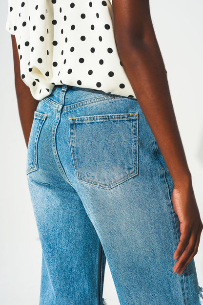 Straight jean in medium wash with rip and split hem