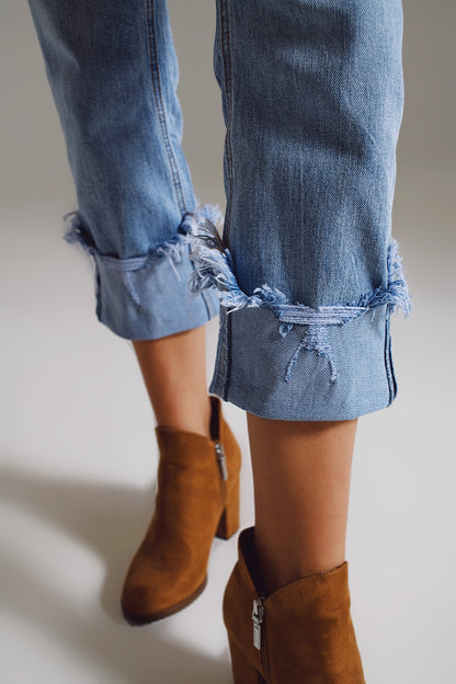Straight leg jeans with distressed hem in light blue