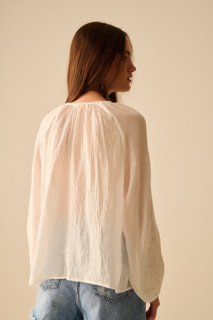white chiffon blouse with embroidery on the sleeves