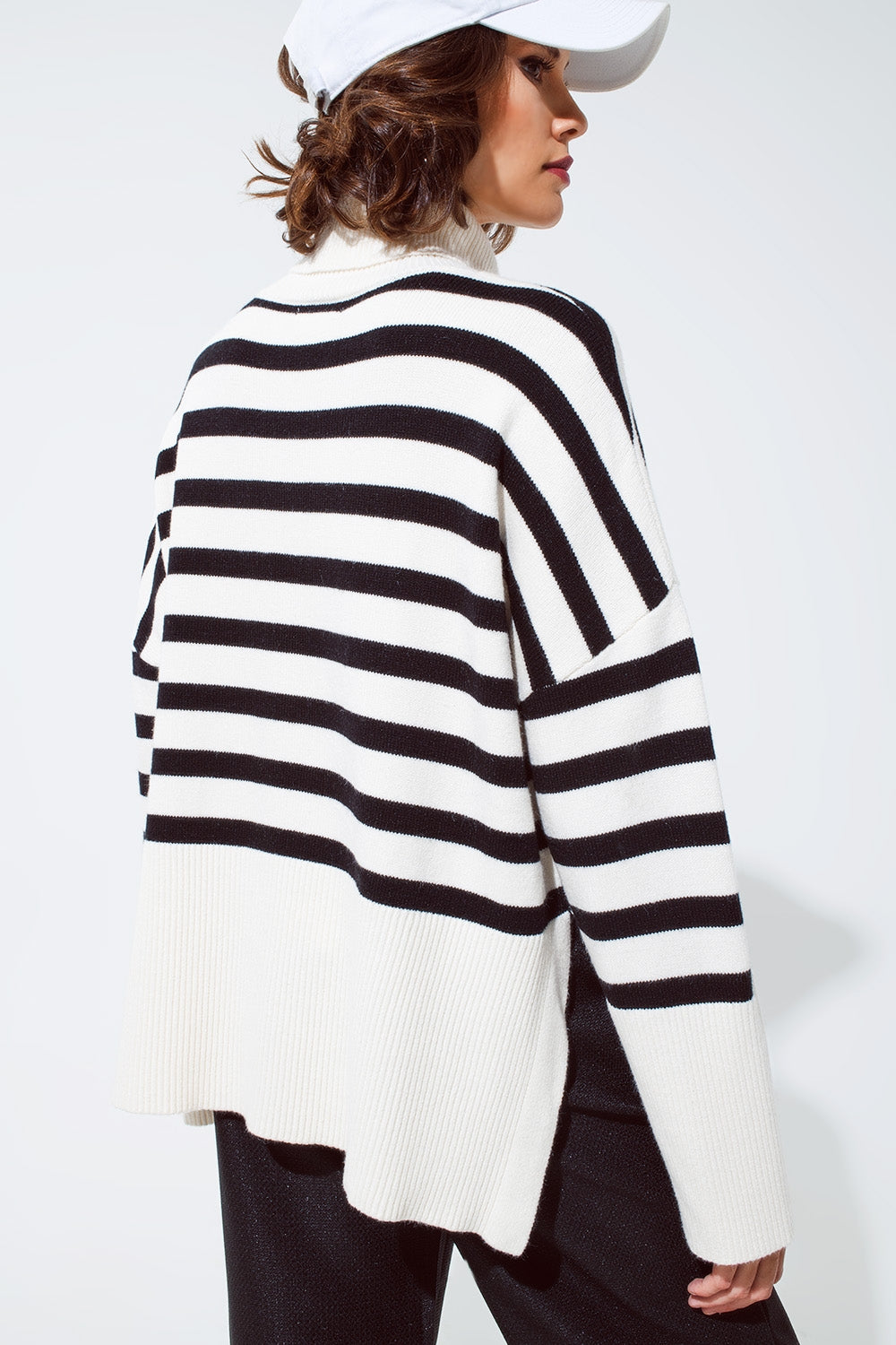 White oversized trutleneck sweater with black stripes and splits on the side